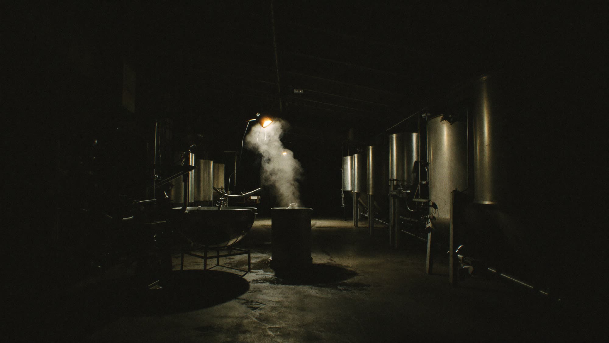 Chemicals: a dim industrial chemical facility with steel vessels